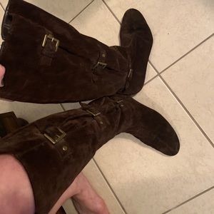 Brown knee high boots. Gold buckles. Zip up.